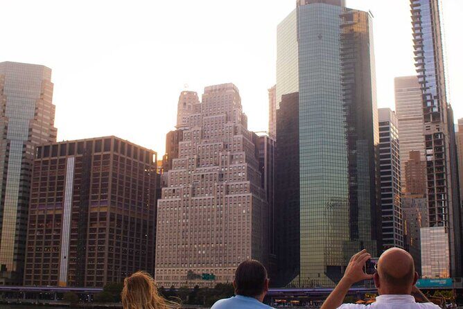 NYC Sunset Cruise Experience the City Twilight Magic - Battery Park and One World Trade Center lighting up the skyline