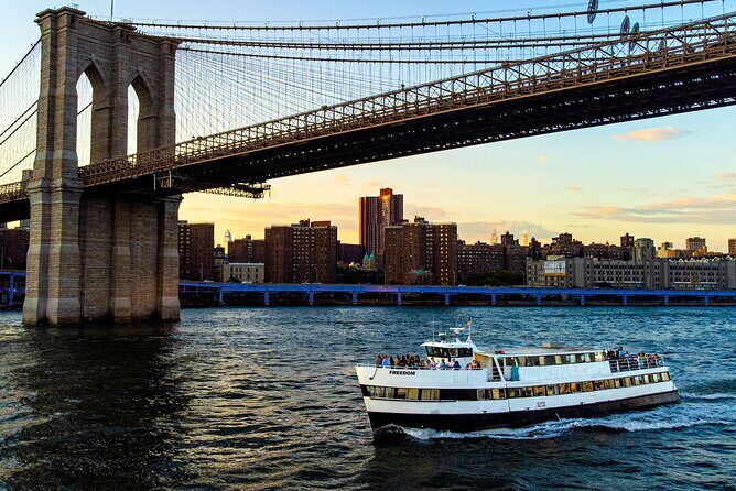 NYC Sunset Cruise Experience the City Twilight Magic - Brooklyn Bridge arches and Manhattan Bridge reflections: where night photos click